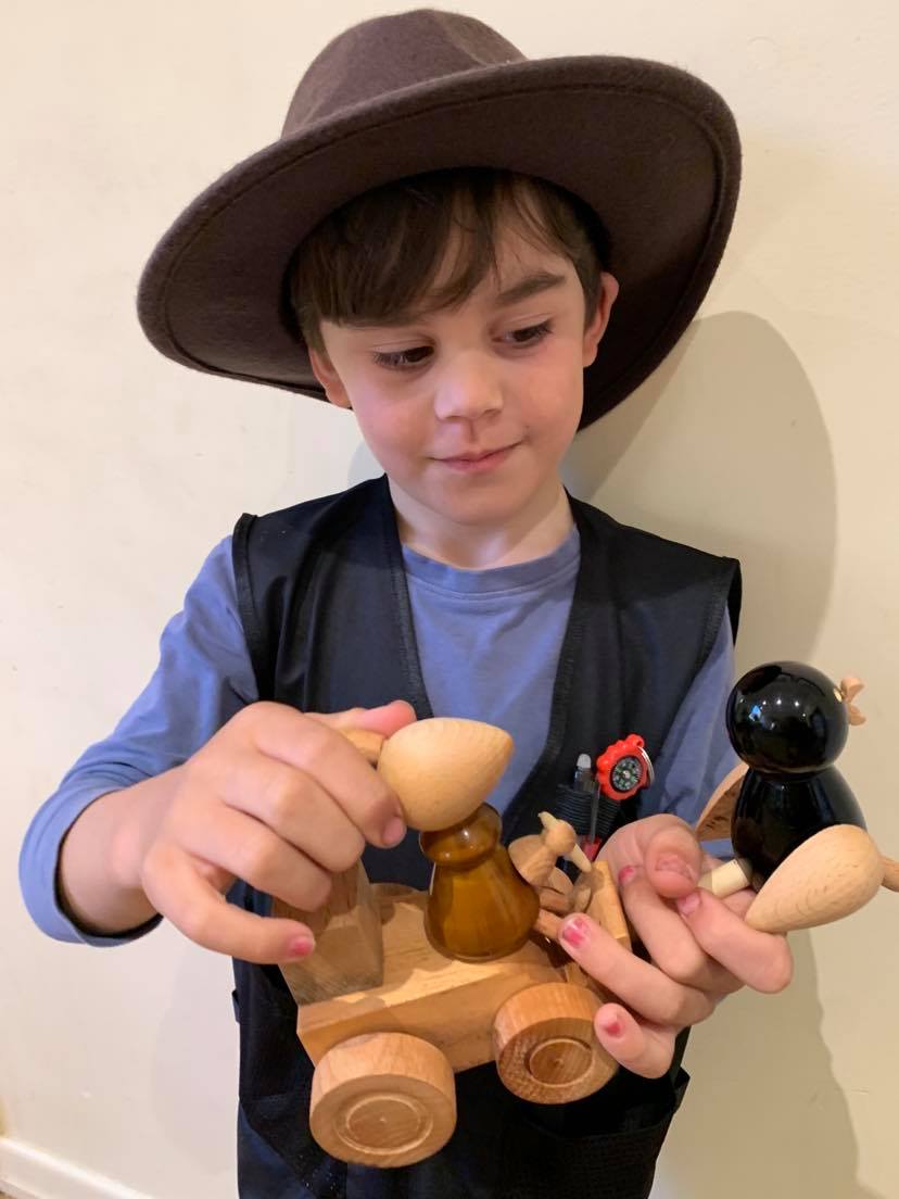 boy with handmade wooden chick rabbit pull along toy